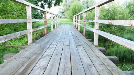 Fototapeta na wymiar Old vintage wooden footbridge. The architecture is an old wooden bridge.