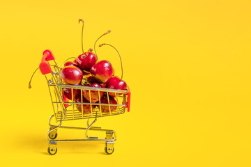 Grocery cart with cherry berries with copy space. Service for delivery app. Online shopping of food market. Fruits delivery concept.