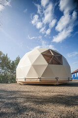 Large geodesic dome tent. Modern outdoor glamping tent.