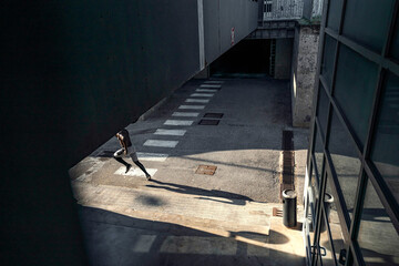 Athletic black man is training in urban area while wearing a mask.