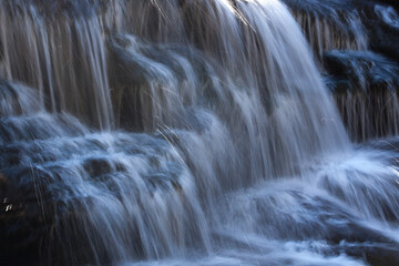 Fototapeta na wymiar Waterfall outdoors with stones