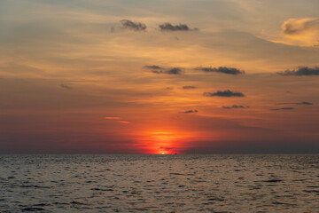 Sunset on the island of Phu Quoc, Vietnam. Travel and nature concept. Evening sky, clouds, sun and sea water