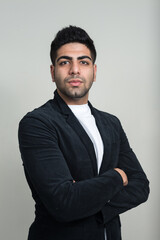 Portrait of young handsome bearded Indian businessman