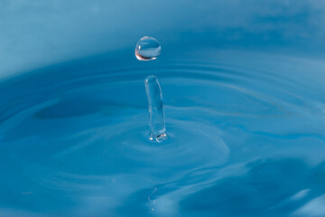 Water clear droplets  higher on the surface  with blue background