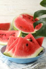 Composition with plate of fresh watermelon on white wooden background