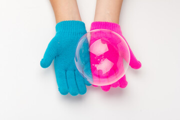 Child in brighte gloves holding soap bubble. happy childhood