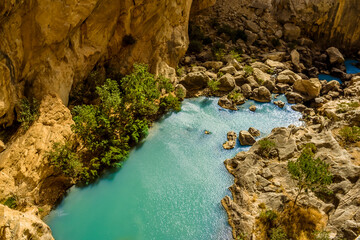 Naklejka na ściany i meble A view looking down on the Gaitanejo river as it flows through the gorge from the Caminito del Rey pathway near Ardales, Spain in the summertime