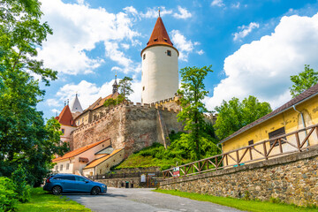 Fototapeta na wymiar The Krivoklat castle, Czech republic. Famous gothic castle built on big rock. Summer day with blue sky and clouds. Famous tourist destination, medieval architecture.
