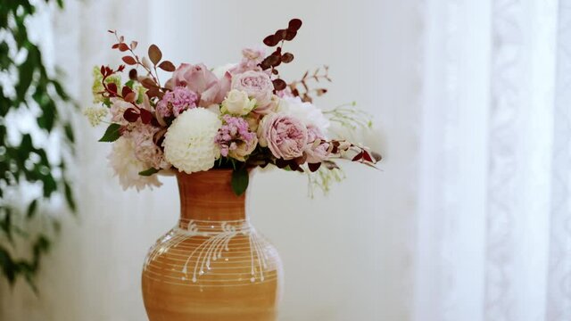 A bouquet of pink flowers in a vase on the table