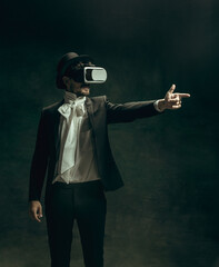His virtual world forever young. Young man in suit as Dorian Gray isolated on dark green...