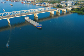 A freight ship has just passed the bridge. Aerial view. 