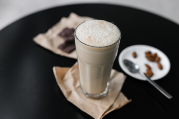 cold coffee frappuccino with foam on the black table