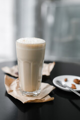 cold coffee frappuccino with foam on the black table
