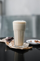 cold coffee frappuccino with foam on the black table