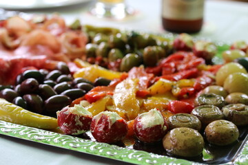 Various antipasti on a silver-colored tray on a table