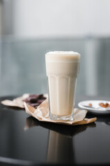 cold coffee frappuccino with foam on the black table