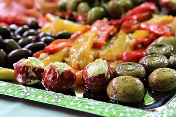 Various antipasti on a silver-colored tray on a table