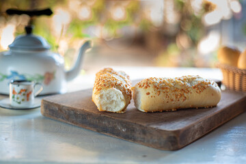 Cafe table with breads, crackers and accessories with blurred background, natural light on white table, selective focus