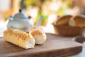 Cafe table with breads, crackers and accessories with blurred background, natural light on white table, selective focus