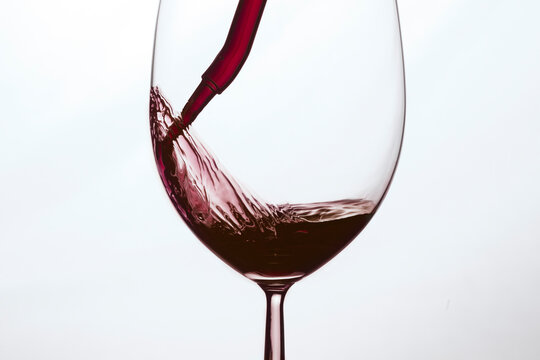 Glass of red wine on white background