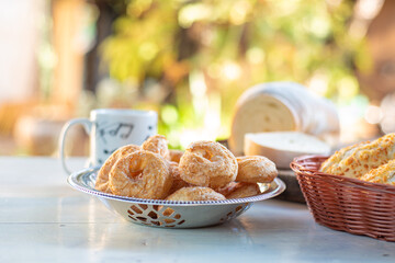 Cafe table with breads, crackers and accessories with blurred background, natural light on white table, selective focus