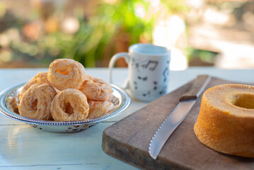 Cafe table with breads, crackers and accessories with blurred background, natural light on white table, selective focus