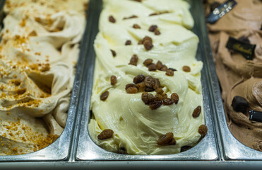 Rum raisin iIalian gelato ice cream in the gelato shop, Italy