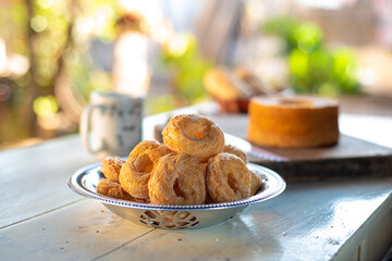 Cafe table with breads, crackers and accessories with blurred background, natural light on white table, selective focus