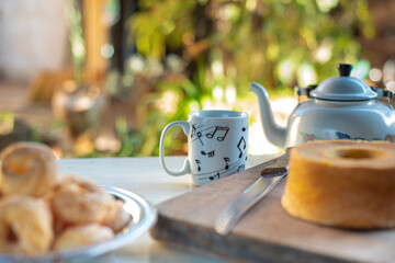 Cafe table with breads, crackers and accessories with blurred background, natural light on white table, selective focus