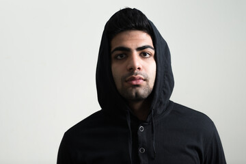 Portrait of young handsome bearded Indian man