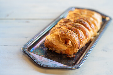 Stuffed bread in tray on the white table with natural light, selective focus