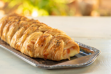 Stuffed bread in tray on the white table with natural light, selective focus