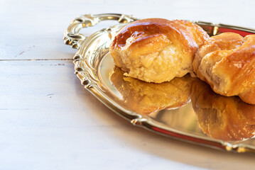Sweet bread on a golden tray with natural light, selective focus