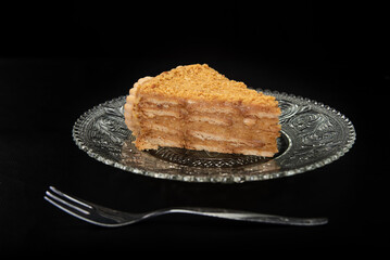 peanut pie on a plate on black table with black background, selective focus
