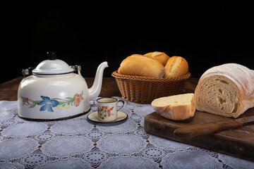 Breakfast table with cookies, breads and accessories on lace tablecloth and rustic wood, selective focus