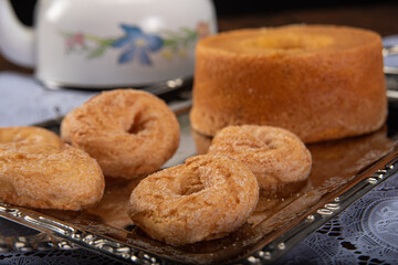 Breakfast table with cookies, breads and accessories on lace tablecloth and rustic wood, selective focus