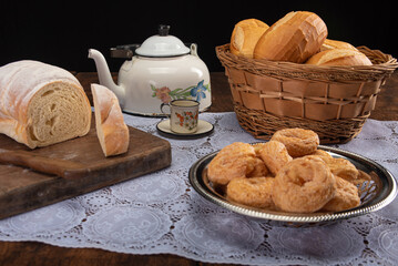 Breakfast table with breads and accessories on rustic wood, selective focus
