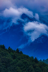 Beautiful landscape with cliff mountain seen through morning fog.