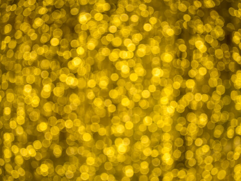 Abstract blurred background of defocused blur bokeh. Festive gold lights bokeh.