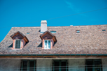 House with a tiled roof against a clear blue sky