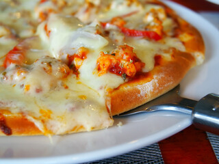 Close Up of Home-made Seafood Cheese Pizza on a white plate , delicious Italian food 