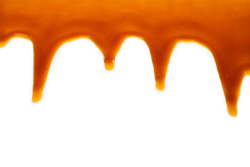 Background of flowing caramel sauce isolated on white.