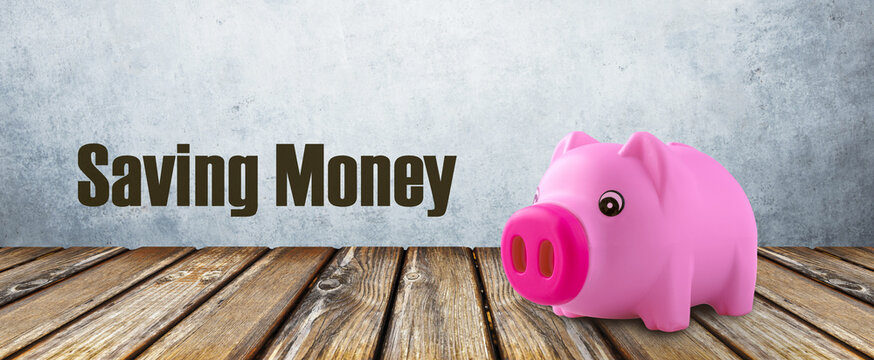 saving money inscription near pink piggy bank, panoramic image