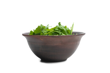 Fresh leaves of arugula in ceramic brown bowl isolated.