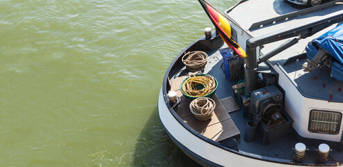 Fototapeta premium Ship's stern of a barge with a German flag over the superstructure motorboat car transport inland waterway transport rope baskets ship technology bollard economic power export rhine main shipping