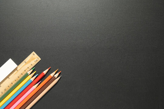 School supplies for background.stationery group of items pencils, pens,ruler,color on blackboard.Back to school concept.