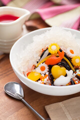 Sweet Ice Jelly Dessert on a Bowl and a Jug of Syrup