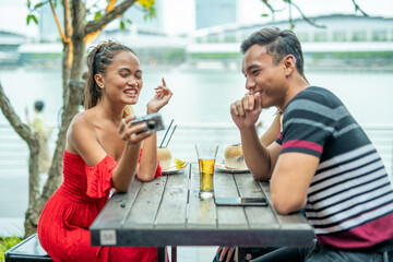 Happy young asian couple meeting outdoor