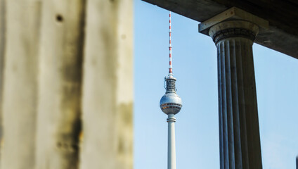 View between pillars of the TV tower at Alexander Platz in Berlin Mitte tourism contrarian...