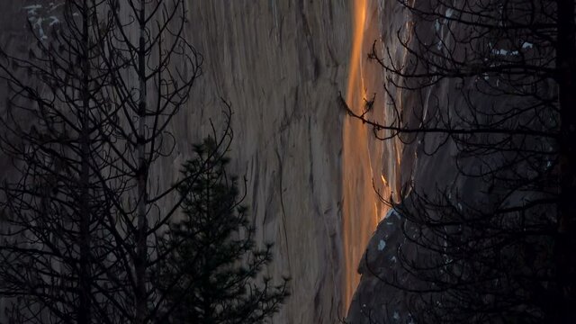Zoom in shot of Firefall-- seasonal Horsetail Falls illuminated by evening sunlight in Yosemite National Park, California